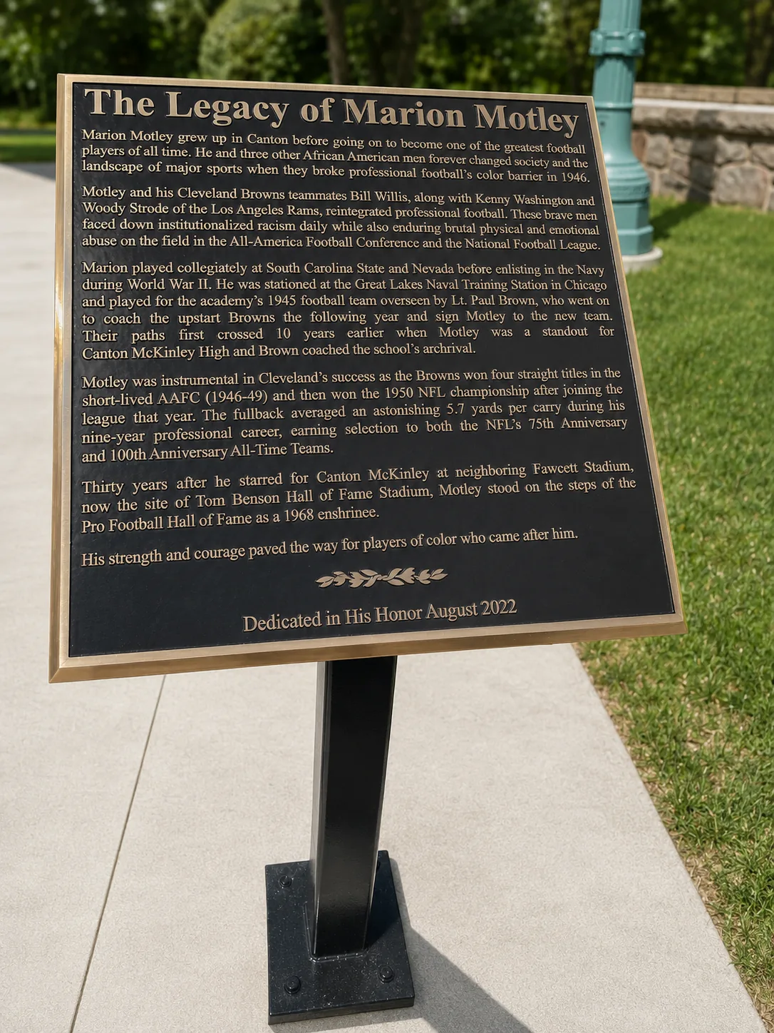 Cast bronze legacy plaque honoring Marion Motley with raised lettering and a dimensional border