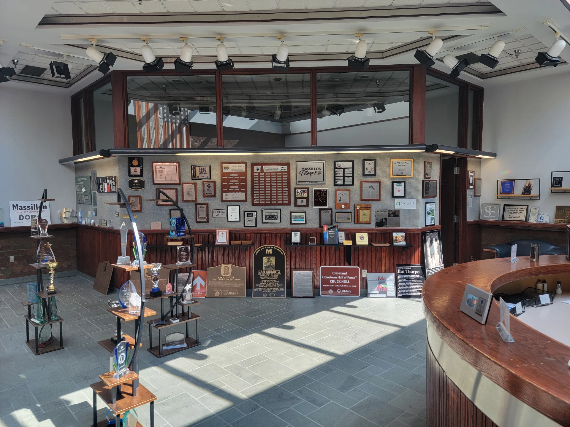 Inside the Massillon Plaque Co. showroom in North Canton, Ohio — wall of plaques, trophy displays, and reception area